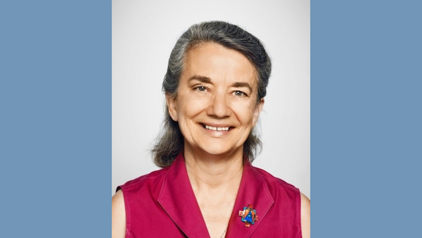 Liz Robinson (Central Philadelphia Monthly Meeting), a board member of QAMAR head shot of herself in a pink blouse with a broach. The Graphic is laid on top of a blue back drop.